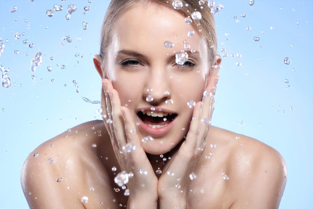 Lady splashing water on face